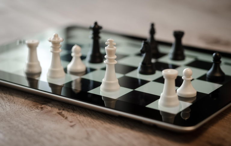 Digital strategy concept represented by a chessboard on a tablet, symbolizing planning and smart moves for business growth online